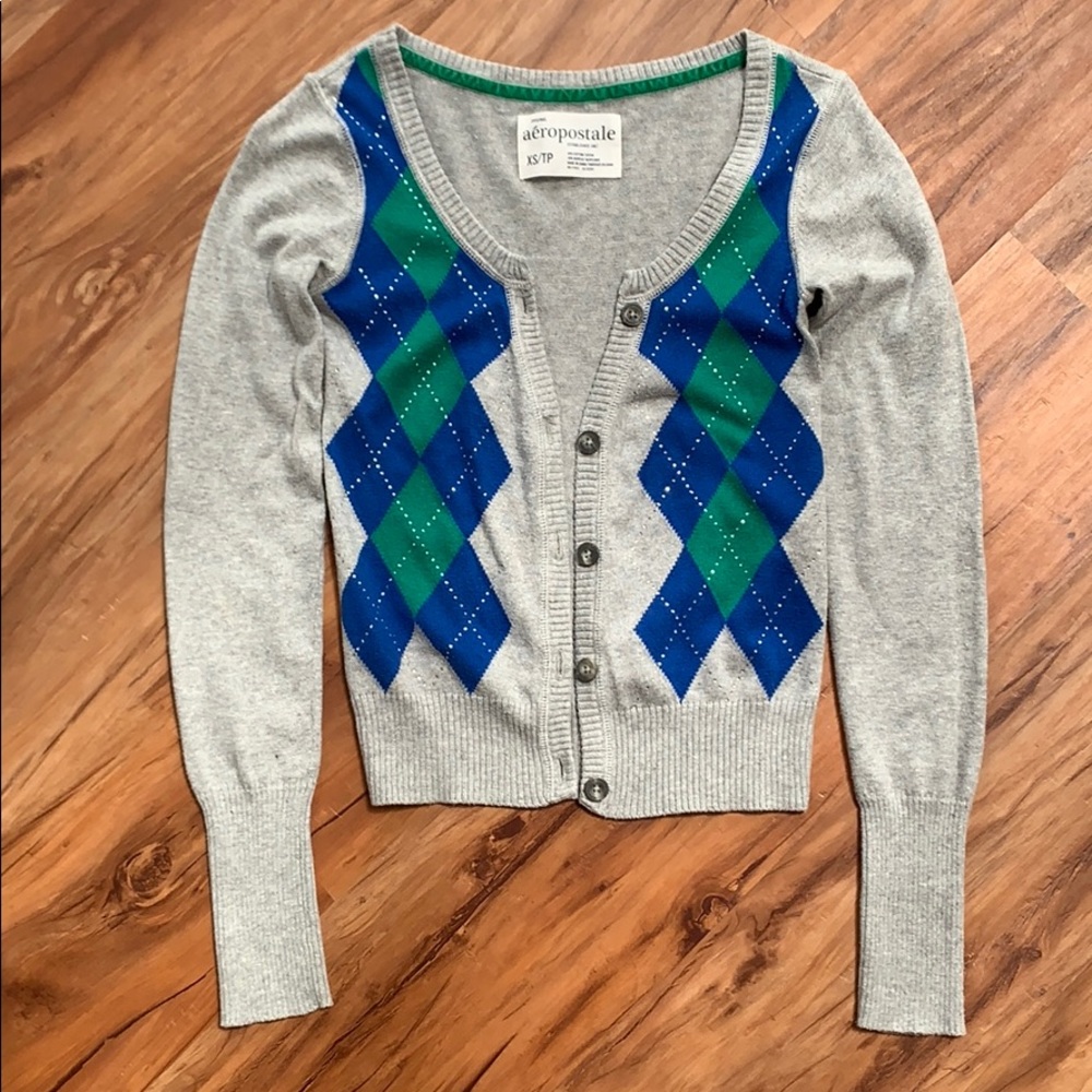 Grey cardigan with blue and green argyle pattern.